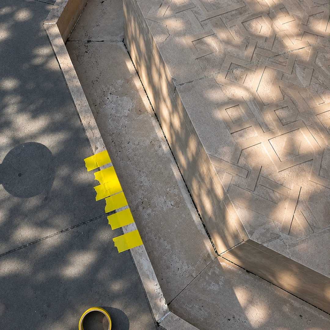Cambridge Central Mosque limestone fountain before repair, with yellow tape marking the damaged edge